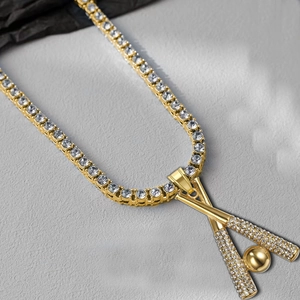 Hip hop gold tennis chain with iced out baseball pendant on stone textured background
