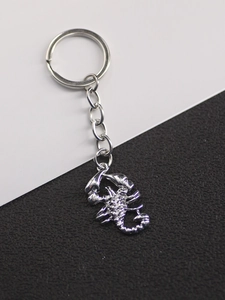 Close-up of a silver vintage scorpion pendant keychain with detailed alloy link chain