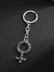 Detail of vintage silver hammered metal keychain featuring a feminine Venus symbol pendant