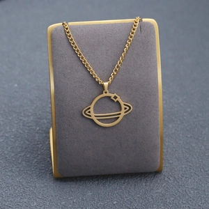 Detailed view of a golden Saturn planet pendant on a delicate chain with a velvet stand