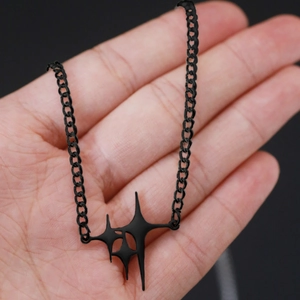 Gothic black metal star pendant necklace with industrial chunky chain held in palm