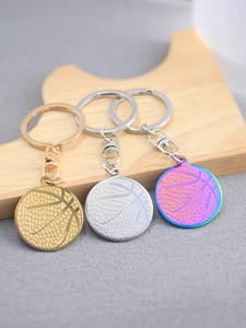 Polished basketball pendants in gold, silver and rainbow colors on wooden blocks