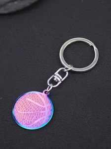 Detailed close-up of rainbow gradient basketball pendant with silver metal keychain hook