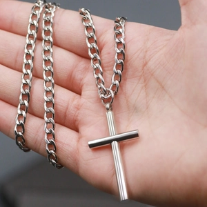 Polished stainless steel cross pendant on thick curb chain necklace for men in minimalist style