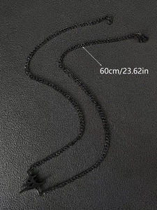 Close-up of a 60cm black punk star pendant necklace with detailed cuban link chain texture