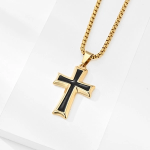 Minimalist gold cross pendant necklace with black inlay on white geometric block