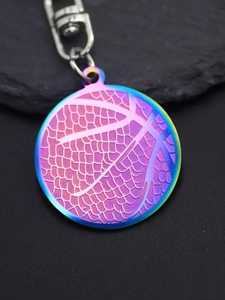 Macro shot of colorful gradient basketball keychain pendant on black stone surface