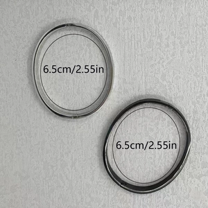 Detail of silver and gun black stainless steel hinged bangles with 6.5cm inner diameter