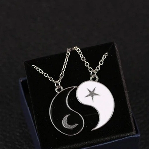 Matching Yin Yang sun and moon pendants on stainless steel necklaces in a gift box