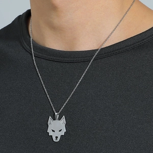 Minimalist stainless steel wolf head pendant necklace on model with black t-shirt