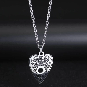 Silver stainless steel heart necklace with Ouija board skull engraving on grey background