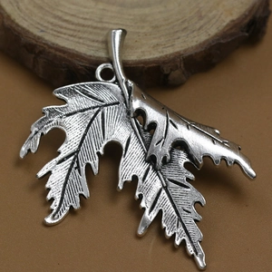 Eco-friendly alloy maple leaf pendant necklace featuring a layered double leaf design
