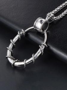 Detailed close-up of a masculine stainless steel oval pendant with twisted wire patterns