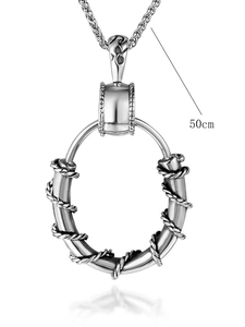 Macro view of stainless steel ring pendant with thorn wire texture and 50cm wheat chain