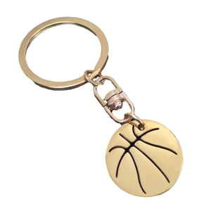 Polished golden basketball pendant keychain with realistic metallic texture on white background