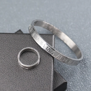 Detail of silver stainless steel bracelet and ring set with engraved Roman numerals