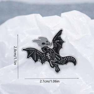 Gothic dragon skeleton enamel pin badge with black oil drip finish on paper background