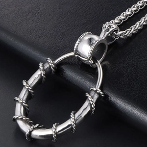 Silver stainless steel oval pendant necklace with thorn texture on black leather