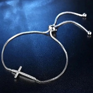 Adjustable cross bracelet with sparkling cubic zirconia on a minimalist silver chain