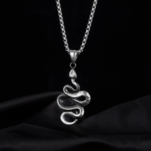 Detailed close-up of a silver snake pendant showing realistic scale textures and metal craftsmanship