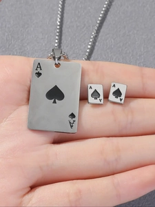 Detailed view of Ace of Spades pendant necklace and matching stud earrings set in hand