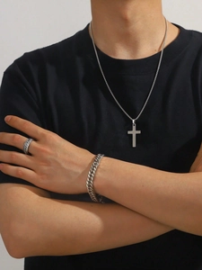 Close-up of men stainless steel cross necklace, cuban link bracelet and rotatable ring