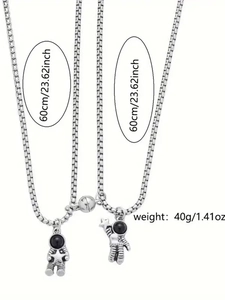Detail view of magnetic astronaut couple necklaces with 60cm chain length and 40g weight