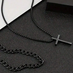 Detailed view of matte black stainless steel cross pendant necklace and cuban link chain set