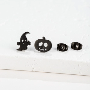 Detail view of black matte stainless steel ghost and pumpkin stud earrings set