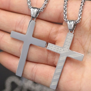Detailed close-up of punk style cross pendants with star etchings and woven chain