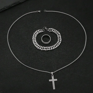 Three-piece titanium steel jewelry set featuring a cross pendant, curb chain, and textured ring