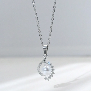 Elegant conch pearl pendant necklace with sparkling diamonds on a silver chain