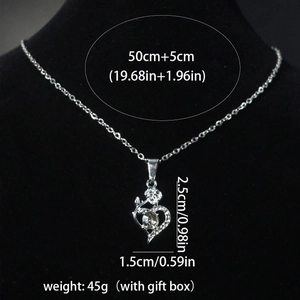 Silver heart necklace with rose flower detail and sparkling crystals on black velvet display