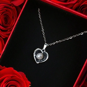 Dettaglio della collana con ciondolo a cuore, perla e strass in confezione regalo