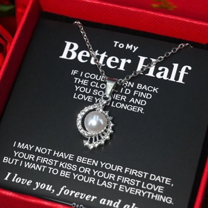 Elegant white pearl pendant necklace with sparkling diamonds and luxury red gift box