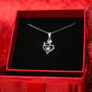 Elegant heart pendant necklace with center crystal in a luxury red jewelry gift box