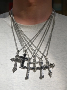 Close-up of 6 silver cross pendant necklaces in various gothic and hip-hop styles
