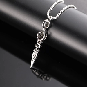 Vintage silver vajra pestle necklace with detailed engravings on a sleek black mirror base