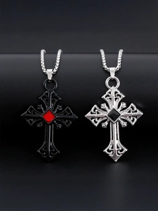 Detail of gothic cross pendants in black and silver finishes with ruby and black gemstones