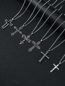 Detailed view of silver cross pendants featuring gothic styles and rhinestone settings