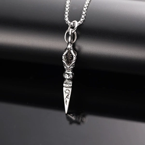 Detailed macro view of the silver Vajra pestle pendant with intricate ethnic patterns