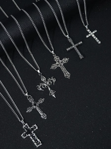 Detailed view of six vintage silver cross pendant necklaces with various gothic designs