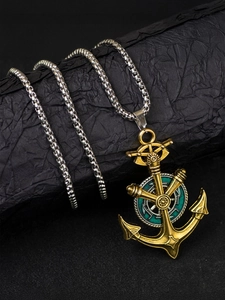 Détail du pendentif ancre vintage avec barre nautique et boussole en émail cyan