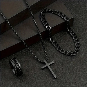 Close-up of matte black stainless steel cross necklace, cuban bracelet and chain ring set