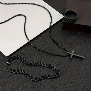 Detail of 3-piece black stainless steel jewelry set with cross necklace and cuban chain
