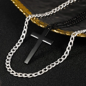 Close-up of double-layer men's necklace with black cross pendant and silver Cuban link