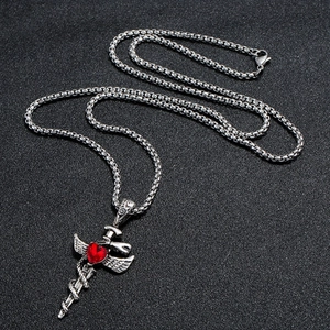 Vintage sword pendant necklace with red heart stone and wings on a black background