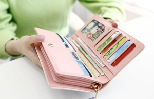 Detail view of long pink faux leather wallet with card slots and zipper coin pocket