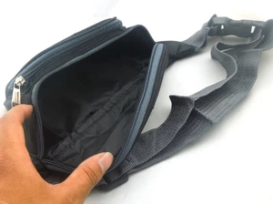 Detail showing the inner main pocket and black lining of the durable nylon waist bag