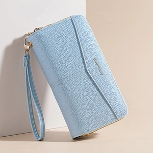 Close-up of light blue litchi pattern leather wallet with wrist strap and gold zipper